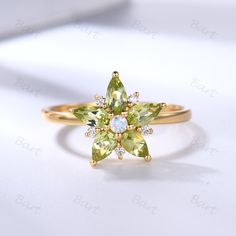 Greenwich Flower Peridot Moonstone Ring, Pear cut peridot moonstone moissanite flower ring, Cluster yellow gold Aug birthstone floral Ring  ◆ Product Specifications Main ring Metal: 10/14/18k Solid Rose/Yellow/White/Black Gold, Platinum, Black/Rose/White/Yellow Gold Plated is available Center stone: 5x3MM pear cut natural peridot Side Stones: moissanite or diamond Setting: Prong, Pave Set If you need diamond option, extra $70 needed it.  Please finish payment in this listing: https://www.etsy.co Green Moonstone Gemstone Ring For Wedding, Green Moonstone Wedding Ring, Green Moonstone Ring For Wedding, August Jewelry, Ring Cluster, Alexandrite Ring, Moonstone Engagement Ring, Floral Ring, Peridot Ring