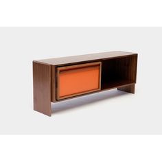 an orange cabinet sitting on top of a white floor next to a wooden shelf with drawers