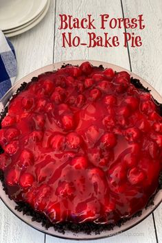 a no bake black forest pie with cherries on top and text overlay that reads, black forest no - bake pie