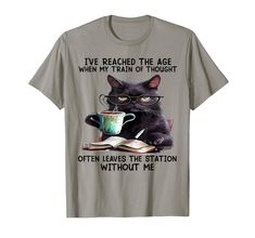 a black cat reading a book and drinking coffee t - shirt with the caption i've reached the age when my train of thought often leaves the station without me