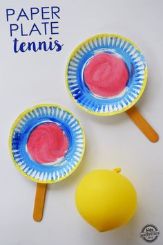 two paper plates with red and blue designs on them next to a yellow plastic lemon