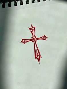 a cross drawn on the side of a white sheet of paper with red ink in it