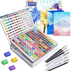 an assortment of art supplies including watercolors, markers and pencils are shown