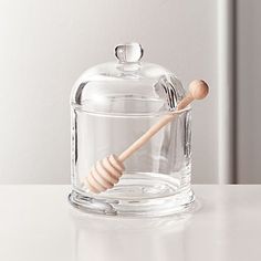 a glass jar with a wooden stick in it