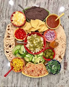 a plate filled with lots of different types of food on top of a marble table