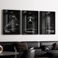 three black and white posters hang on the wall above a couch in a living room