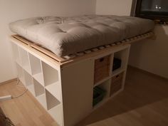 a bed that is sitting on top of a shelf