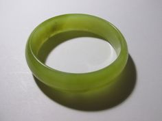 This smaller-sized jade bangle comes in a yellow-green color. It is dainty in size and yet has some weight to it. (AD) Adjustable Green Round Bangle, Adjustable Green Bangle, Adjustable Green Jade Bangle, Chinese Greens, Health Hygiene, Purple Jade, White Jade, Jade Bangle, Jade Ring