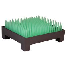 a black and green display case with rows of plastic spikes on it's sides