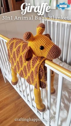 a crocheted giraffe stuffed animal hanging from the side of a crib