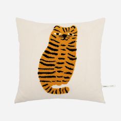 a white pillow with a tiger embroidered on it