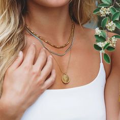 Stacking pieces you can't do without! This dainty coin and beaded chain look amazing on any stack, with a vintage look and feel, combined with the water + tarnish resistant materials that allow for everyday wear! Product Details Material: Stainless Steel, 18k plated chain Coin size: 3/4" Chain size: 18" Gold Medallion Necklace, Gold Coin Necklace, Gold Medallion, Beach Surf, Dainty Gold Necklace, Medallion Necklace, 925 Sterling Silver Chain, Beach Vibes, Coin Necklace