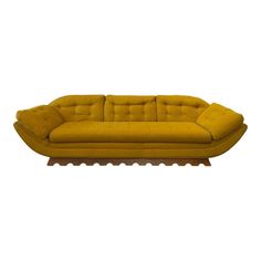 a yellow couch sitting on top of a wooden table