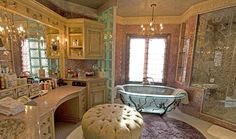 a fancy bathroom with a claw foot tub and chandelier