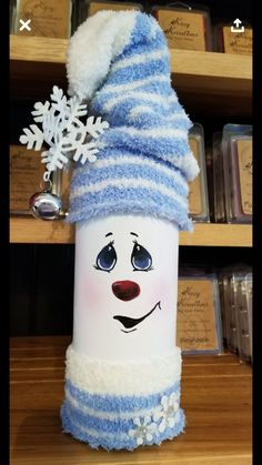 a white and blue frosty cup with a snowman hat on it's head