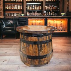 a wooden barrel sitting on top of a hard wood floor next to a bar filled with bottles