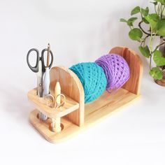 a pair of scissors and some yarn in a holder