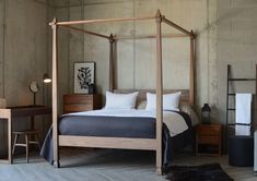 a bedroom with a four poster bed and wooden furniture