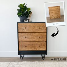 a wooden dresser sitting in front of a white wall next to a potted plant