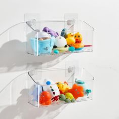 two clear shelves filled with plastic toys on top of a white wall next to each other