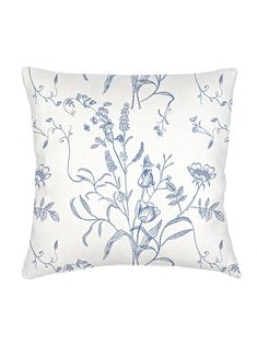 a blue and white floral pillow on a white background with an image of flowers in the middle