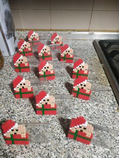 a bunch of legos that are sitting on a counter top in the shape of santa's hats