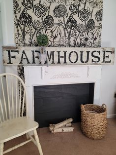 a white chair sitting next to a fireplace with a sign above it that says farmhouse