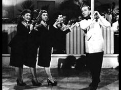 three women in black and white dresses dancing on the dance floor with their hands together