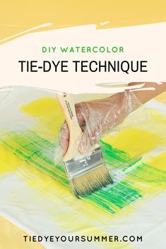 a person holding a paintbrush over some yellow and green paint with the words diy watercolor tie - dye technique