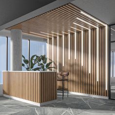 an office with wooden slatted walls and a plant in the corner by the counter