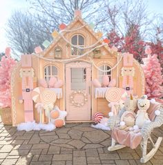 a pink doll house with teddy bears in front