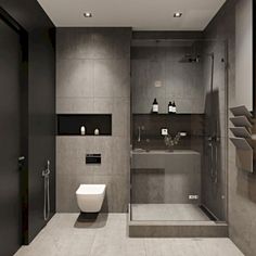 a bathroom with a toilet, sink and shower stall in the middle of it's walls