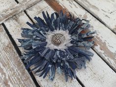 a blue and white brooch sitting on top of a wooden floor