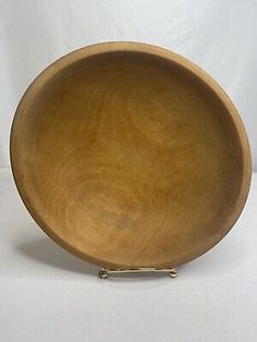 an empty wooden bowl on a white background