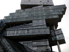 a very tall building with many balconies on it's sides and windows