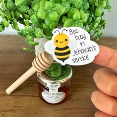 a hand holding a honey jar with a sticker that says bee busy in jelloah's service