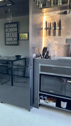 a microwave oven sitting inside of a kitchen next to a dining room table