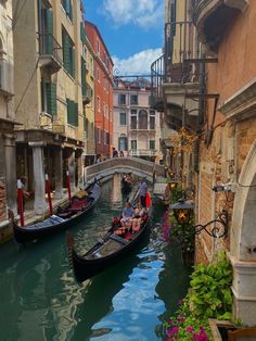 two gondola boats are going down the canal