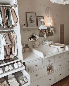 a baby's closet with lots of clothes and shoes