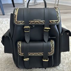 Grafea Hari Ii Greek Black Backpack Never Used Comes With Dust Bag Luxury Large Capacity Standard Backpack, Luxury Large Capacity Shoulder Backpack, Luxury Large Capacity Backpack For Errands, Designer Rectangular Shoulder Bag For School, Luxury Rectangular Satchel For School, Luxury Large Capacity Rectangular Leather Backpack, Everyday Rectangular Backpack With Gold-tone Hardware, Luxury Backpack With Gold-tone Hardware For Everyday Use, Luxury Rectangular Shoulder Bag For School