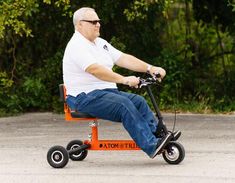 an older man is sitting on a motorized scooter in the parking lot with trees behind him