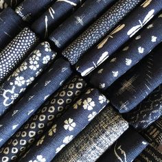 a pile of black and white umbrellas sitting next to each other