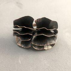 a close up of a flower shaped object on a white table top with no one around it