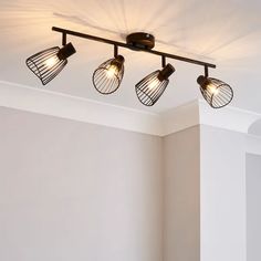 three light fixtures in a room with white walls