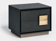 a black and gold nightstand with two drawers on each side, one drawer has an open brass square in the middle