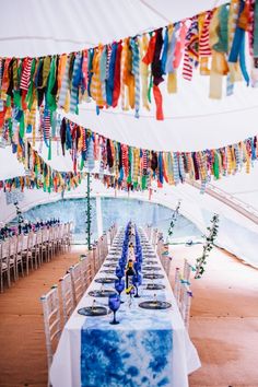 a long table is set up with blue and white linens