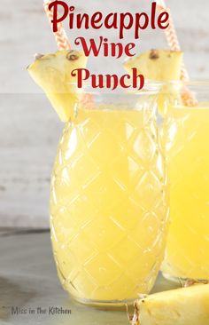 pineapple wine punch in a pitcher with two pieces of fruit next to it and the title overlay reads pineapple wine punch