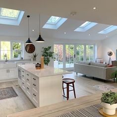 an open kitchen and living room with skylights