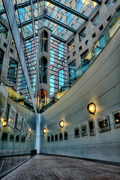 the inside of a large building with many windows and lights on it's sides