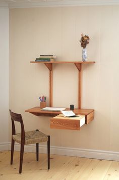 a wooden desk with a book shelf above it